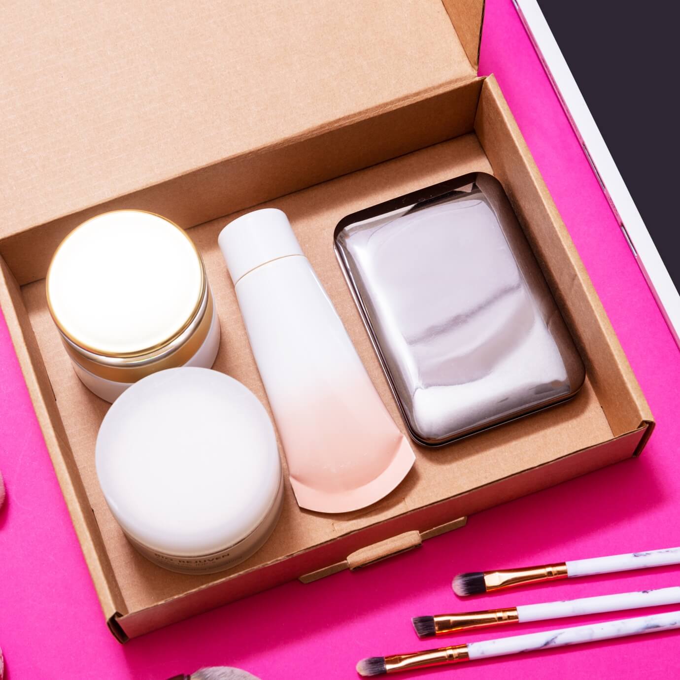 image corrugated box holding beauty products on neon pink table thumbnail